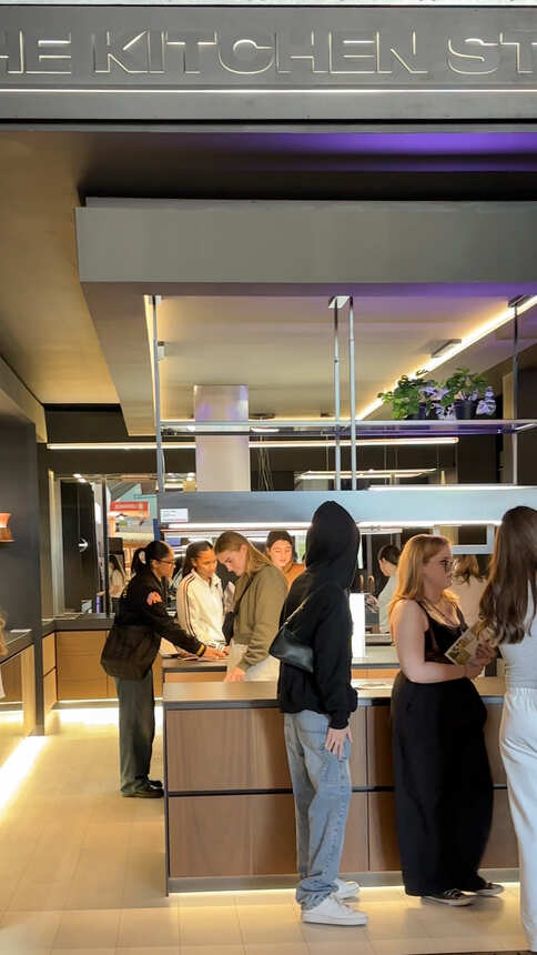 Students exploring a kitchen showroom display