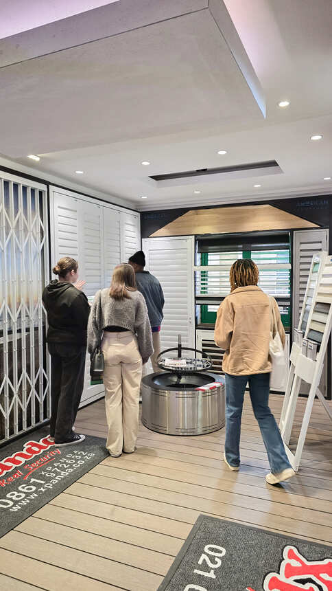 Students looking at window shutter and security gate displays